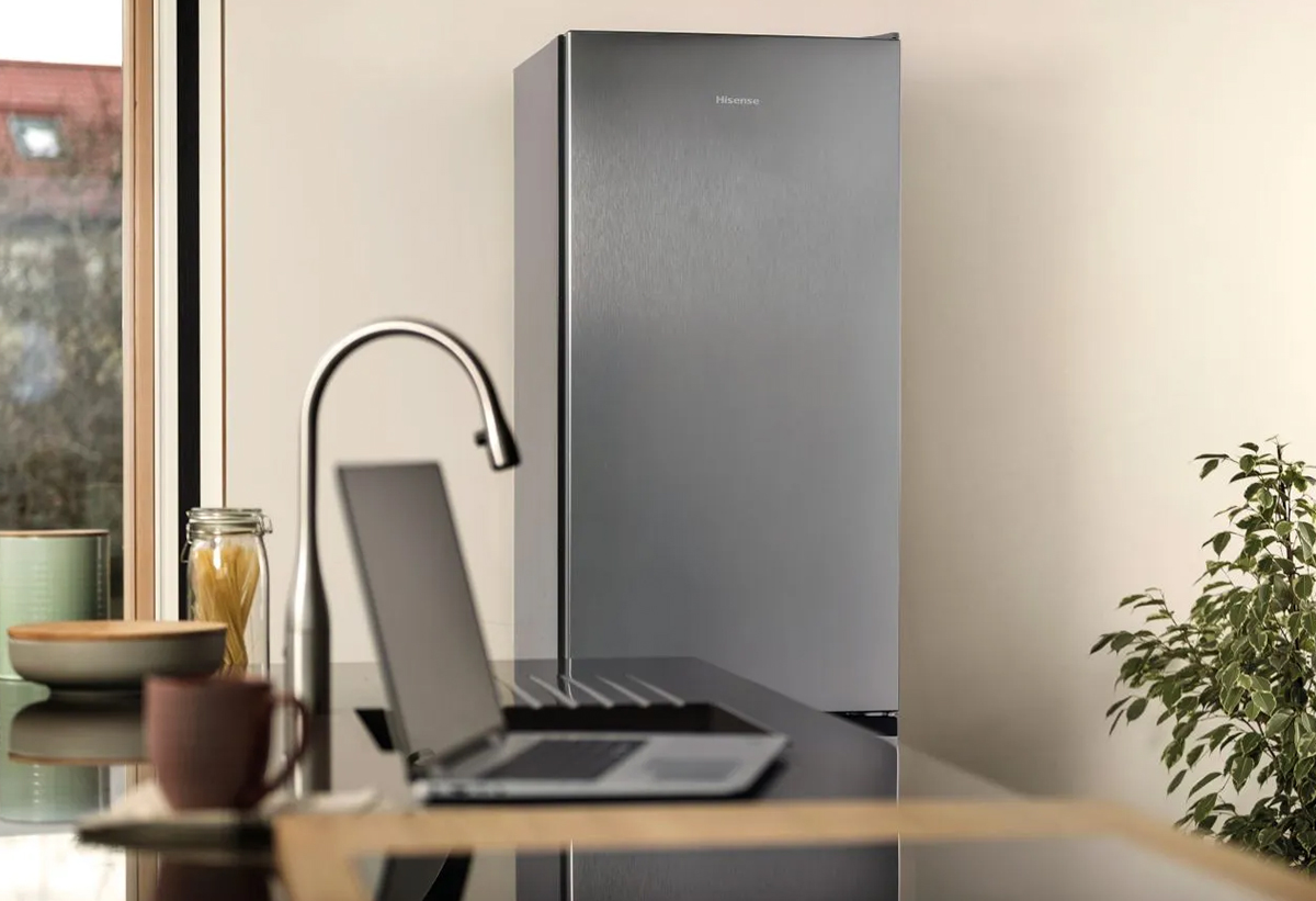 Απεικονίζεται το ψυγείο δίπλα σε γραφείο.